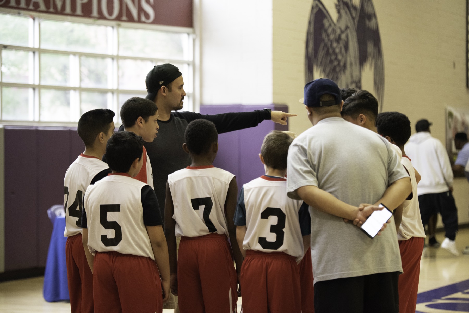 Coach leading a team huddle