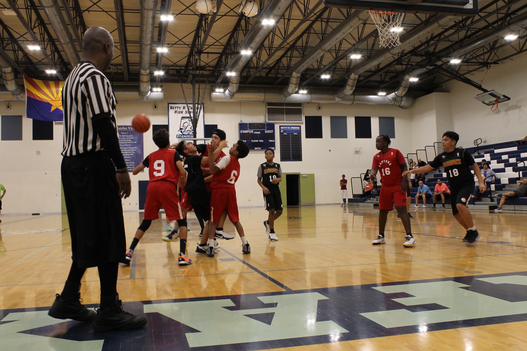 Game in progress with the referee watching
